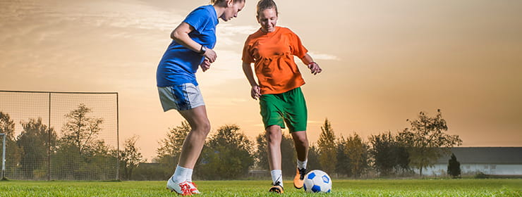 Two Women playing a football match